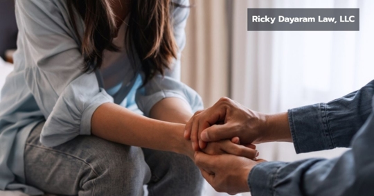 Young man comforting and supporting a sad woman after wrongful death